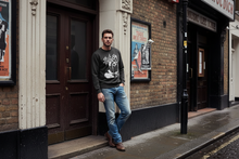 Load image into Gallery viewer, Model wearing the Jerry Lee Lewis 1972 Wembley sweatshirt outside a London music venue
